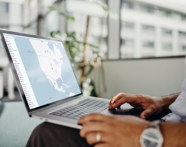 Man sitting with a laptop on his lap looking at a screen with NordVPN on it